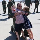 Commander Aaron Carlson hugs his children after returning from a six-month tour on the USS Roosevelt.
